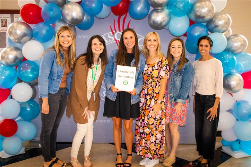 A group of teachers smile
